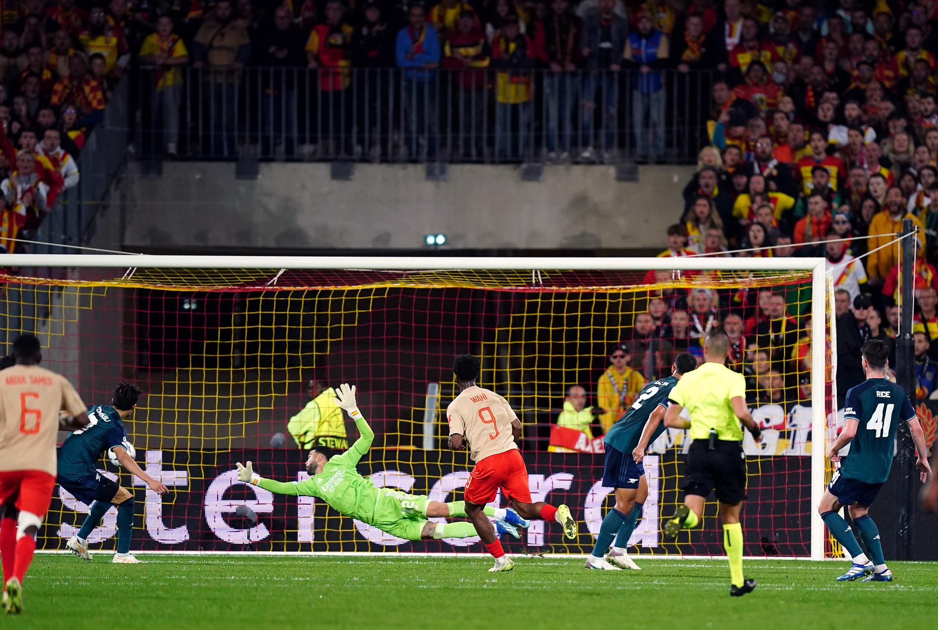 First score: Elie Wahi scores Lens' goal, 2-1, amid huge cheers from the home team's fans. 