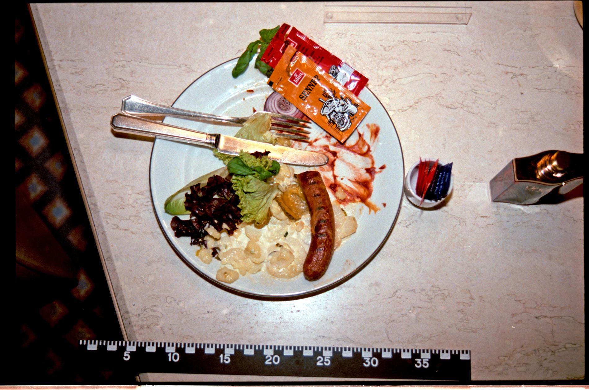 LAST MEAL: The plate of sausages and potato salad was ordered through room service. 