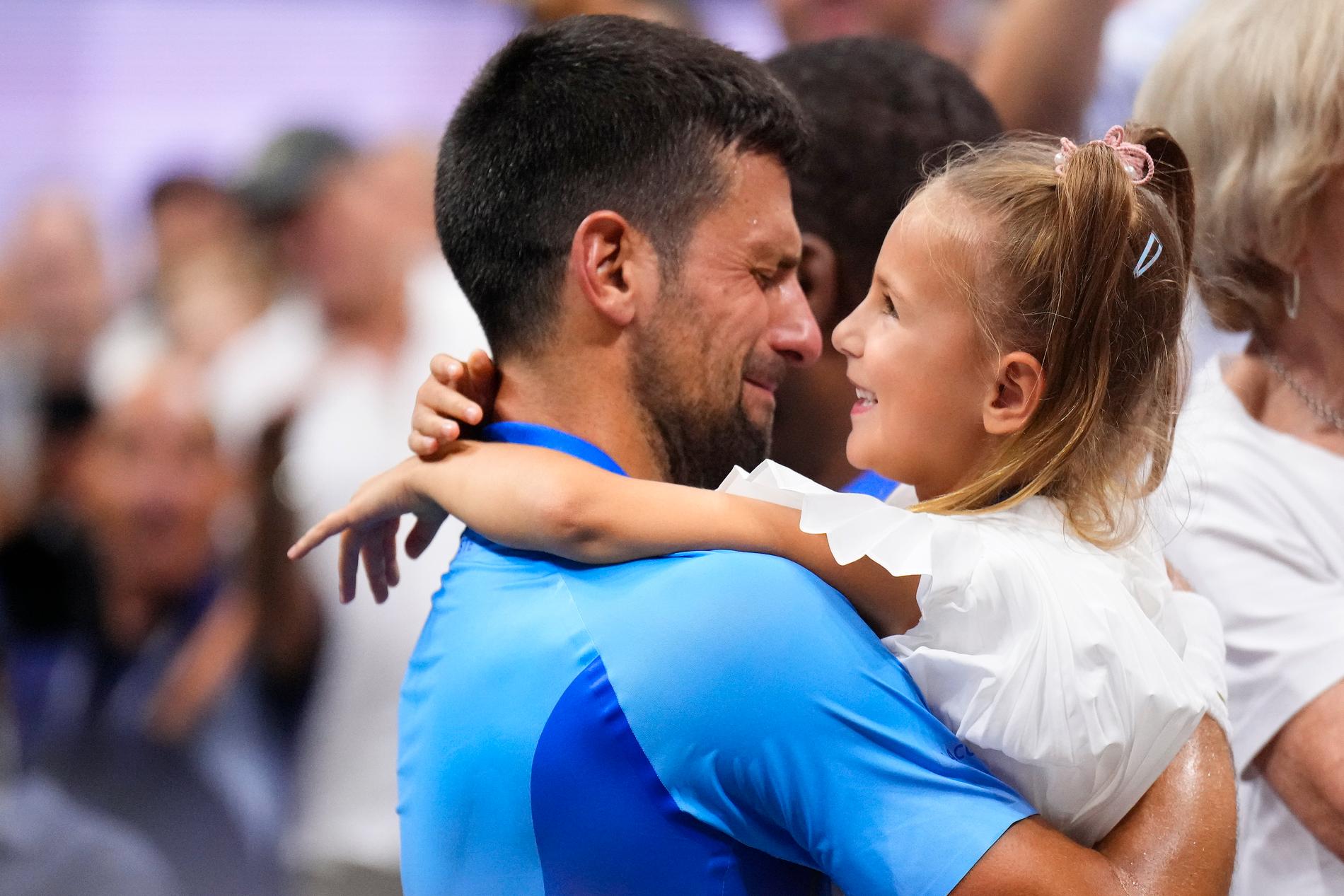 Family man: Novak Djokovic breaks free with his daughter Tara after the win.