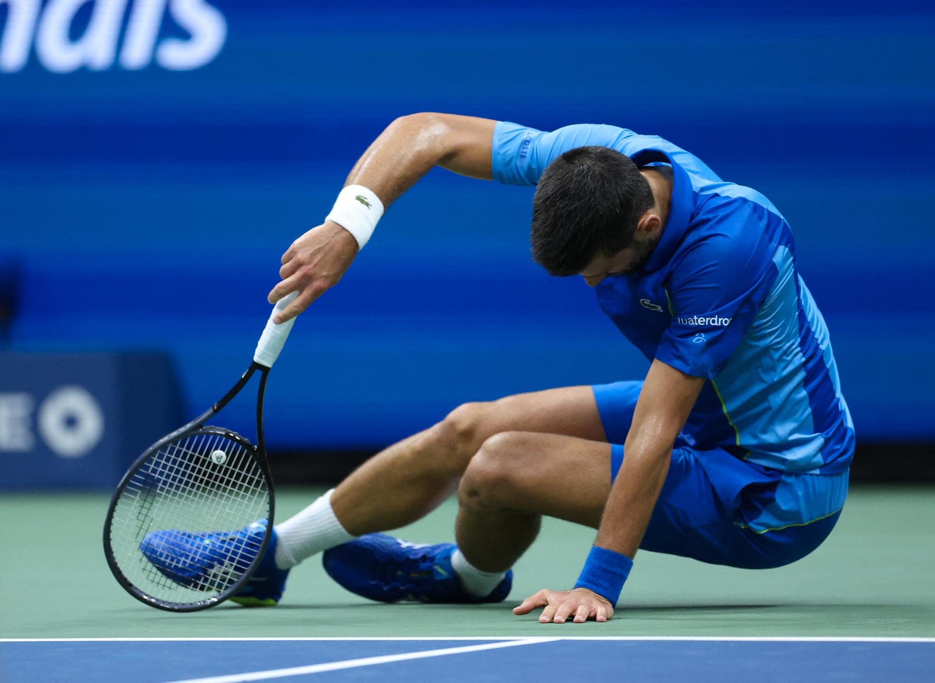 Tired: Novak Djokovic was so tired that he lay down to rest midway through the second set.
