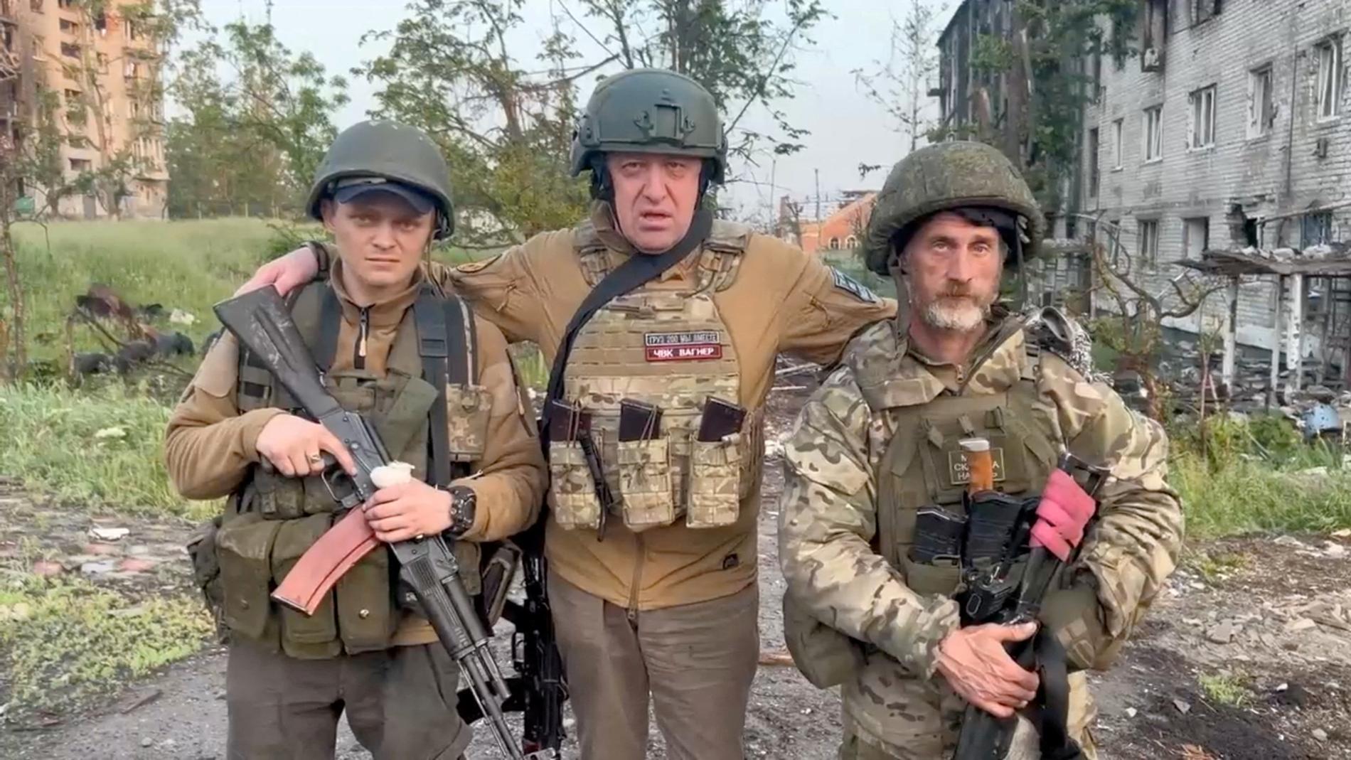 Photo of Yevgeny Prigozhin with two Wagner soldiers outside Bakhmut in May 2023.