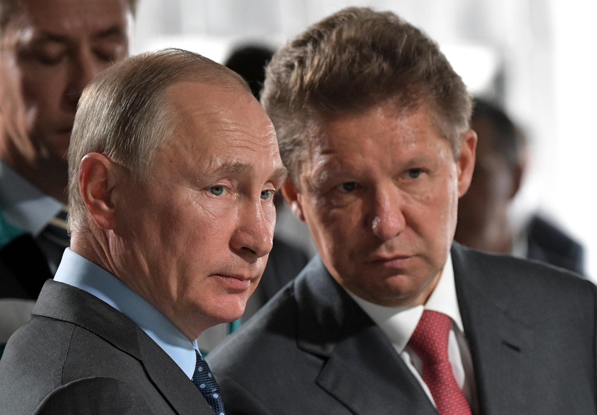Vladimir Putin with Gazprom CEO Alexei Miller (right).