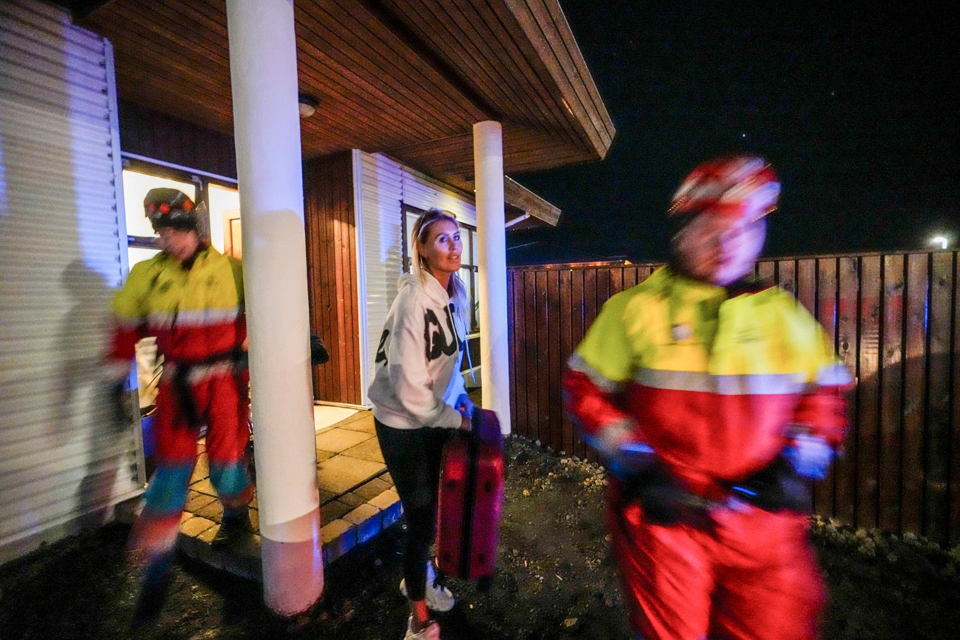 In everything: A woman takes with her a bag containing some of her belongings as she is evacuated from her home in Grindavik on Saturday night. 