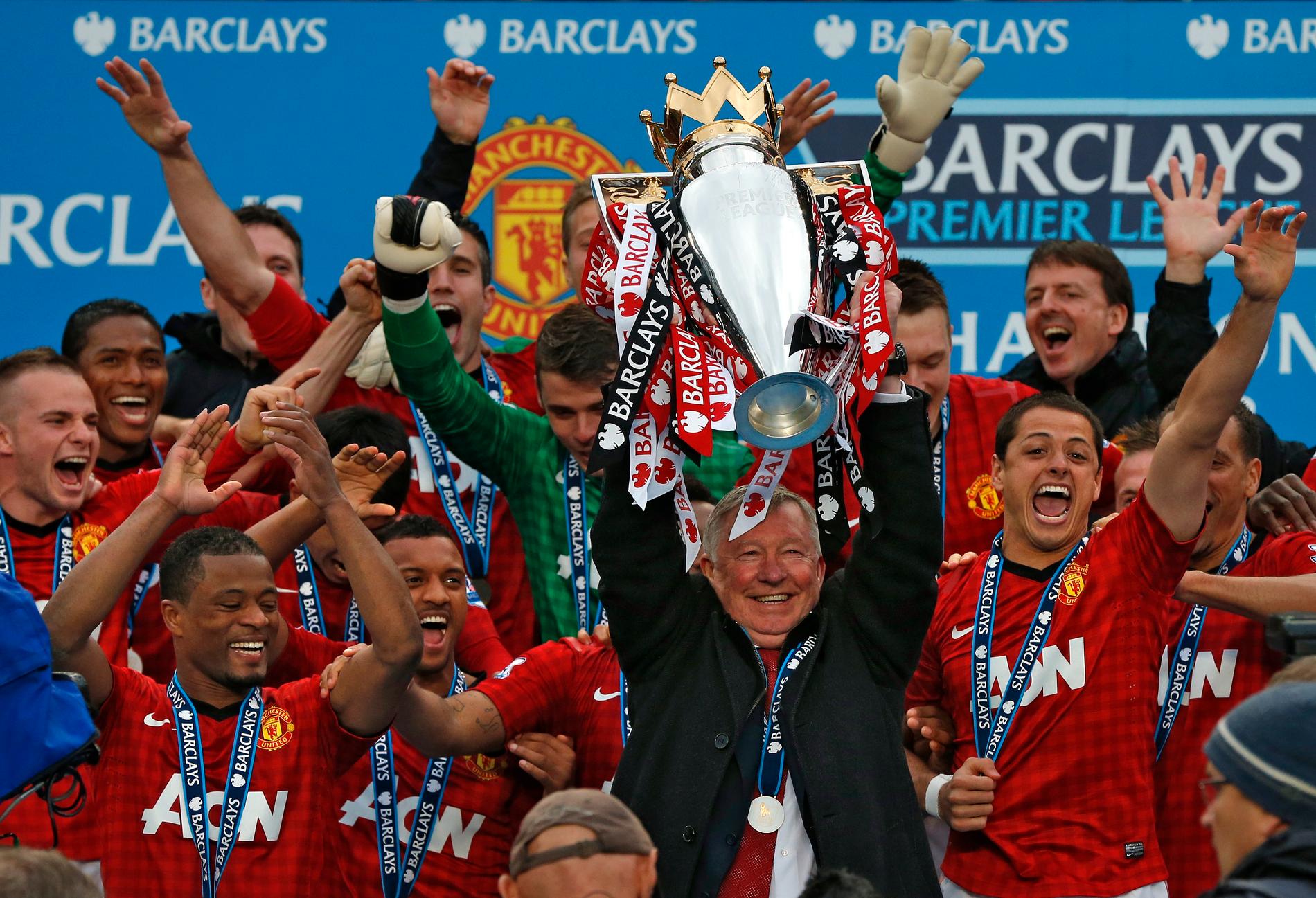 Winner: Alex Ferguson lifts the latest in an endless string of silverware, following the league gold medal in 2013.
