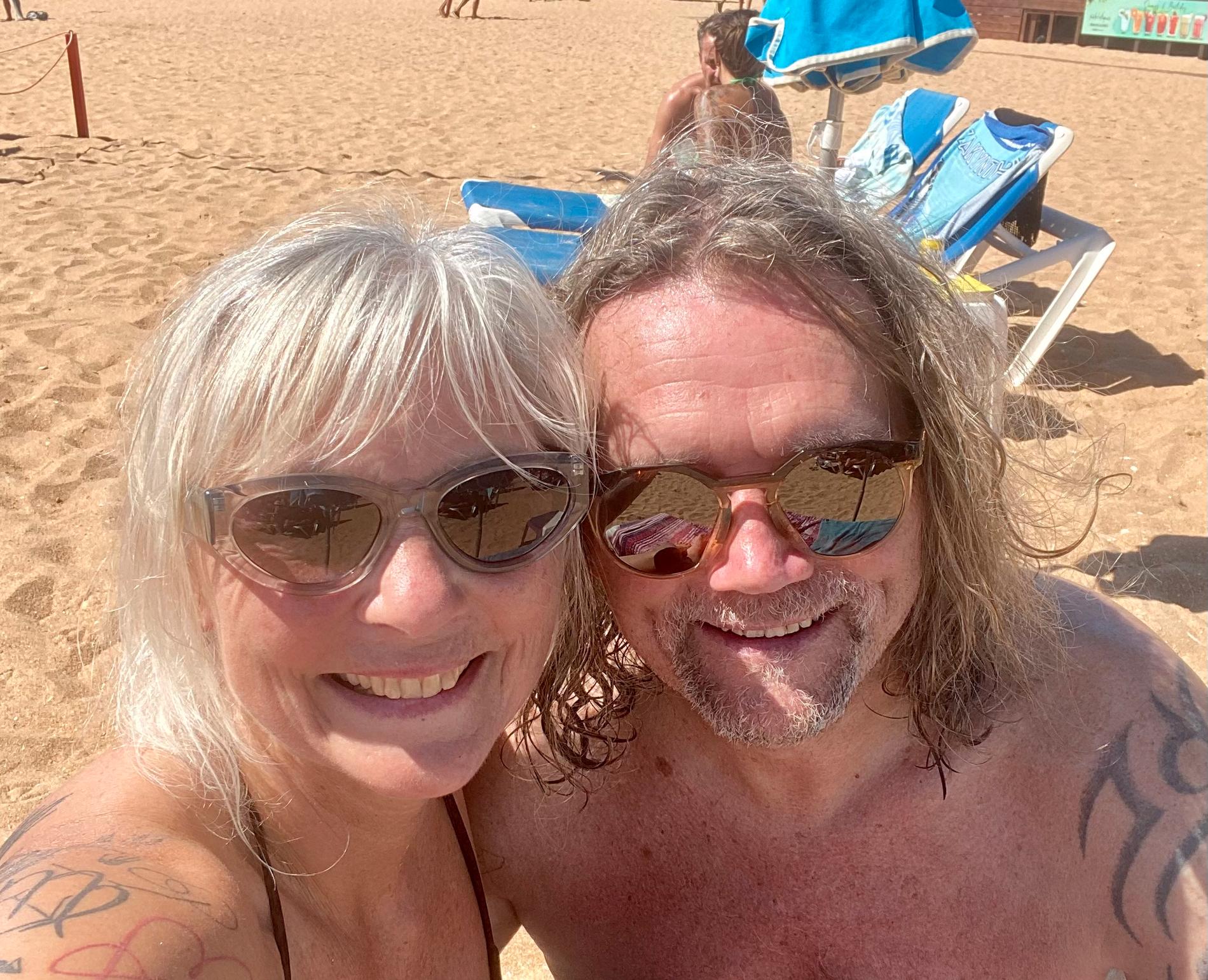 On the Beach: When Viji talks to the couple, they are each sitting on a sunbed on a beach in Portugal. 