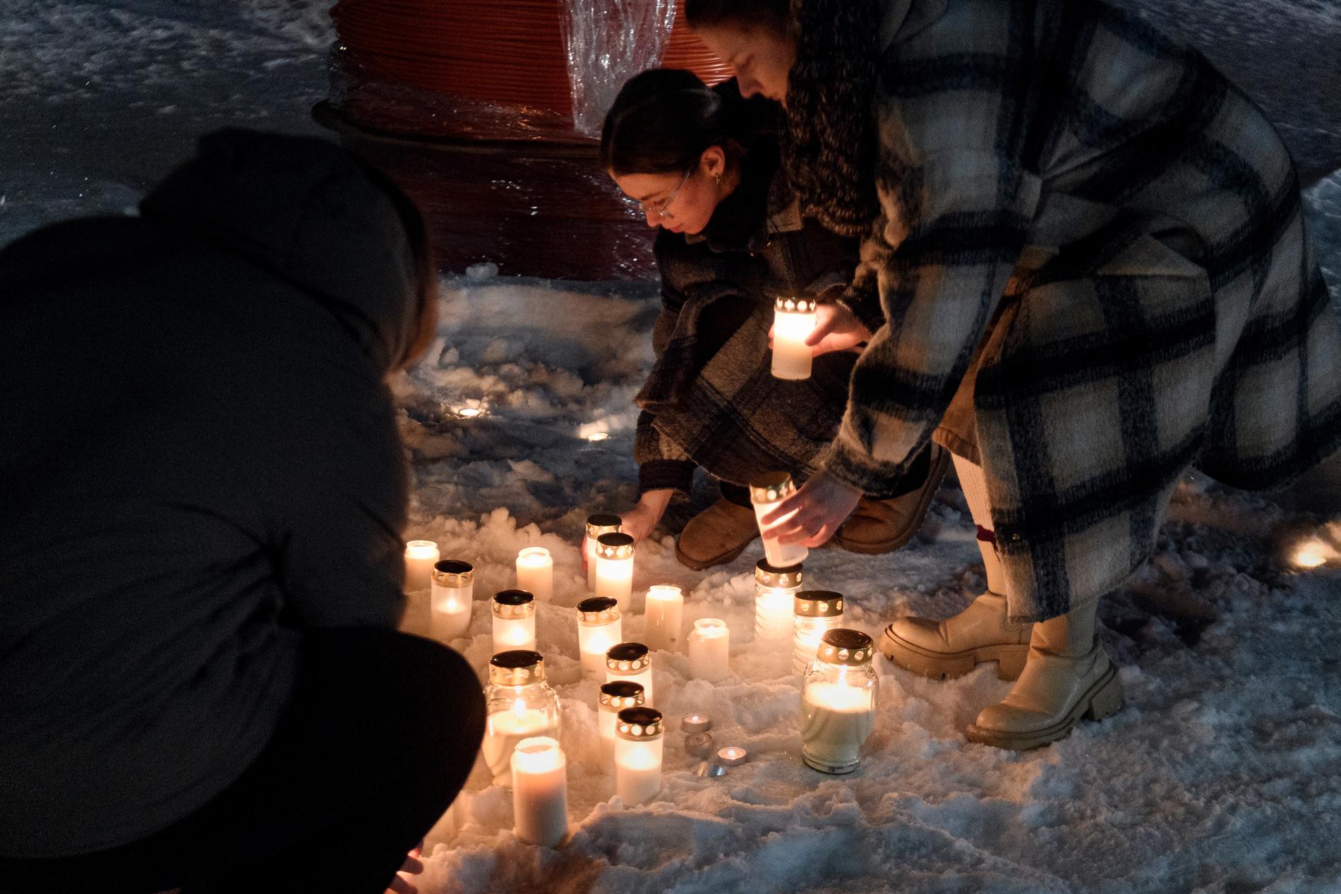 Mourning: Villagers light candles and lay flowers. 