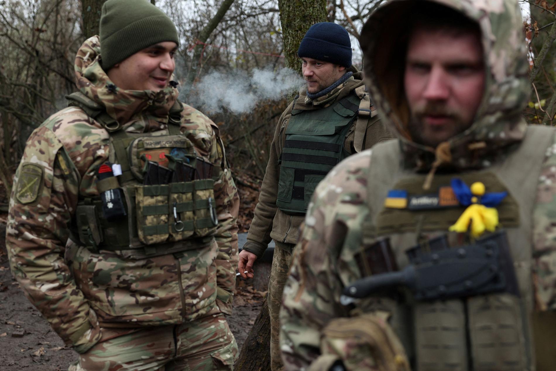 In the foreground: Ukrainian soldiers take a break near the front line in Bakhmut, Donetsk, on November 18.