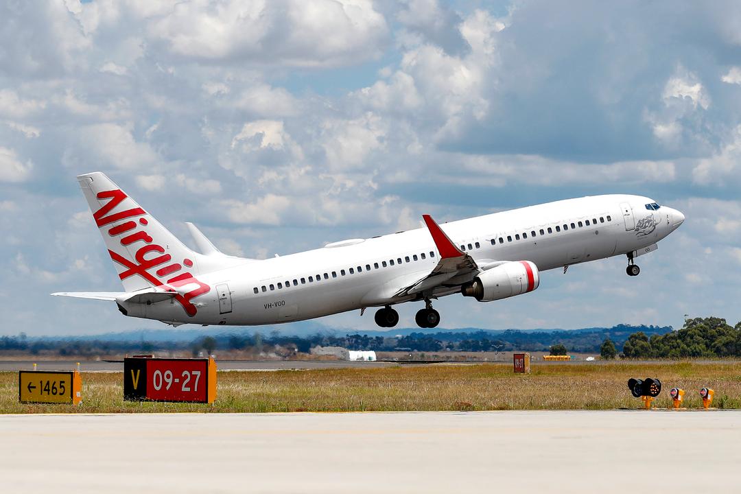 A naked man runs frantically on a plane in Australia