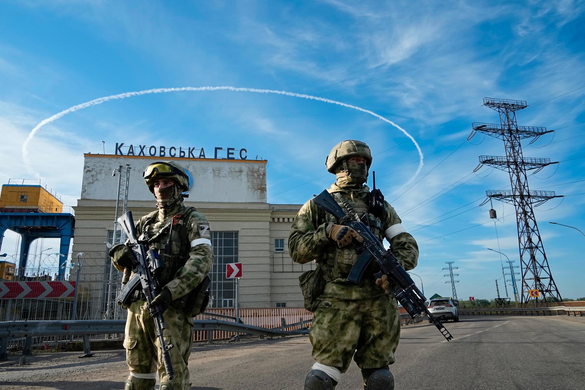 Russian soldiers guard a power plant in Russian-occupied territory in the Kherson region.