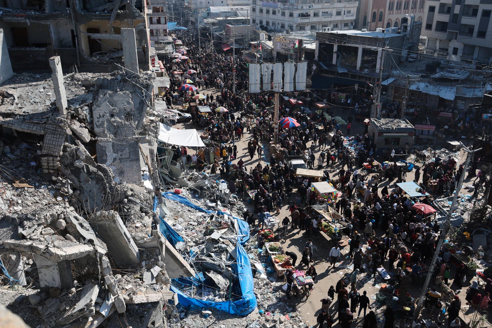 Traces: Palestinians search for a market among the ruins of the Nuseirat refugee camp in Gaza on Thursday.