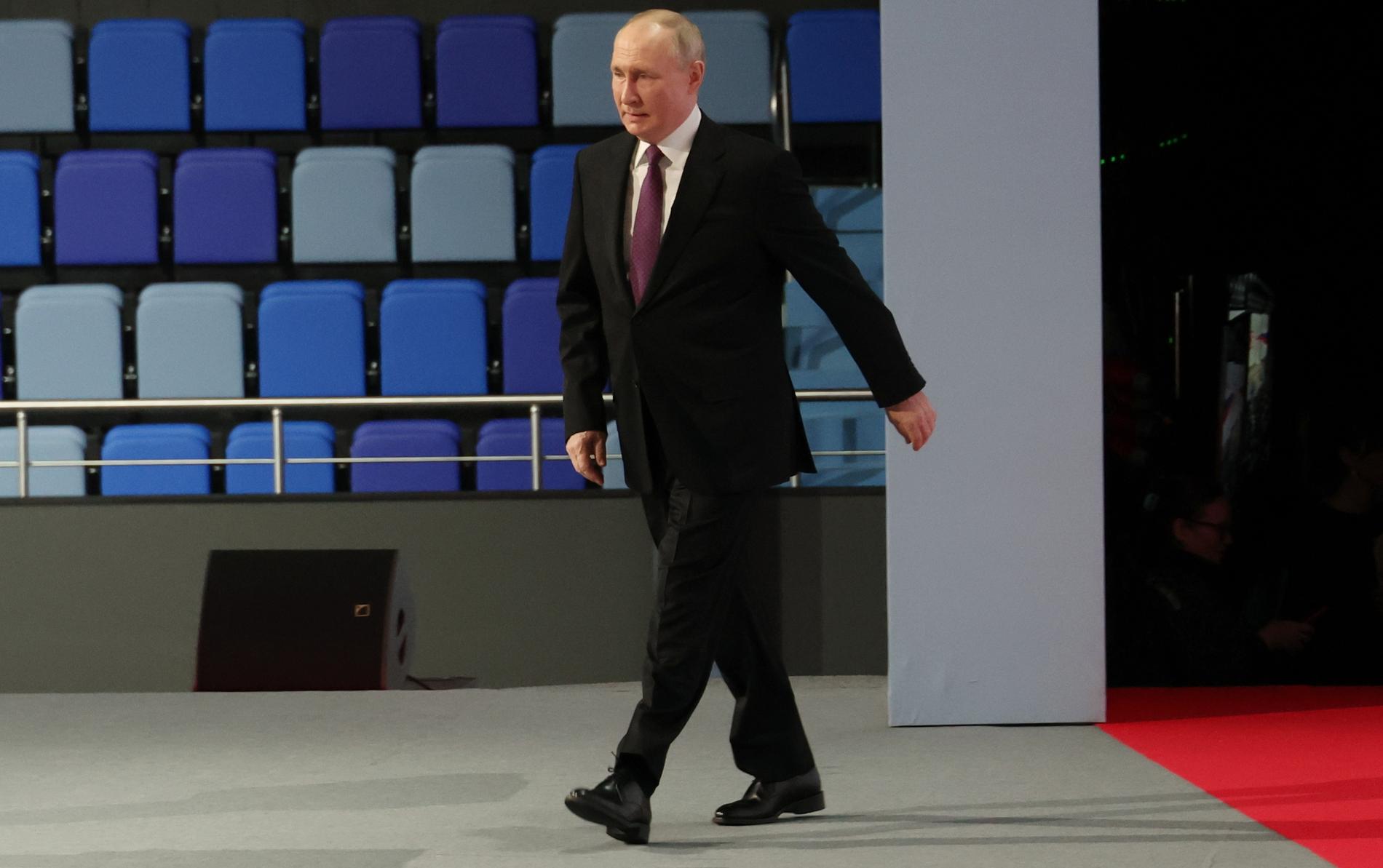 Vladimir Putin arrives at a railway conference on Friday.