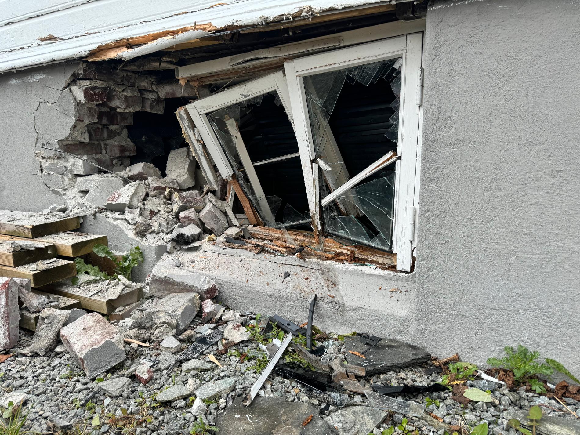 Damage: Window broken and brick wall smashed. 