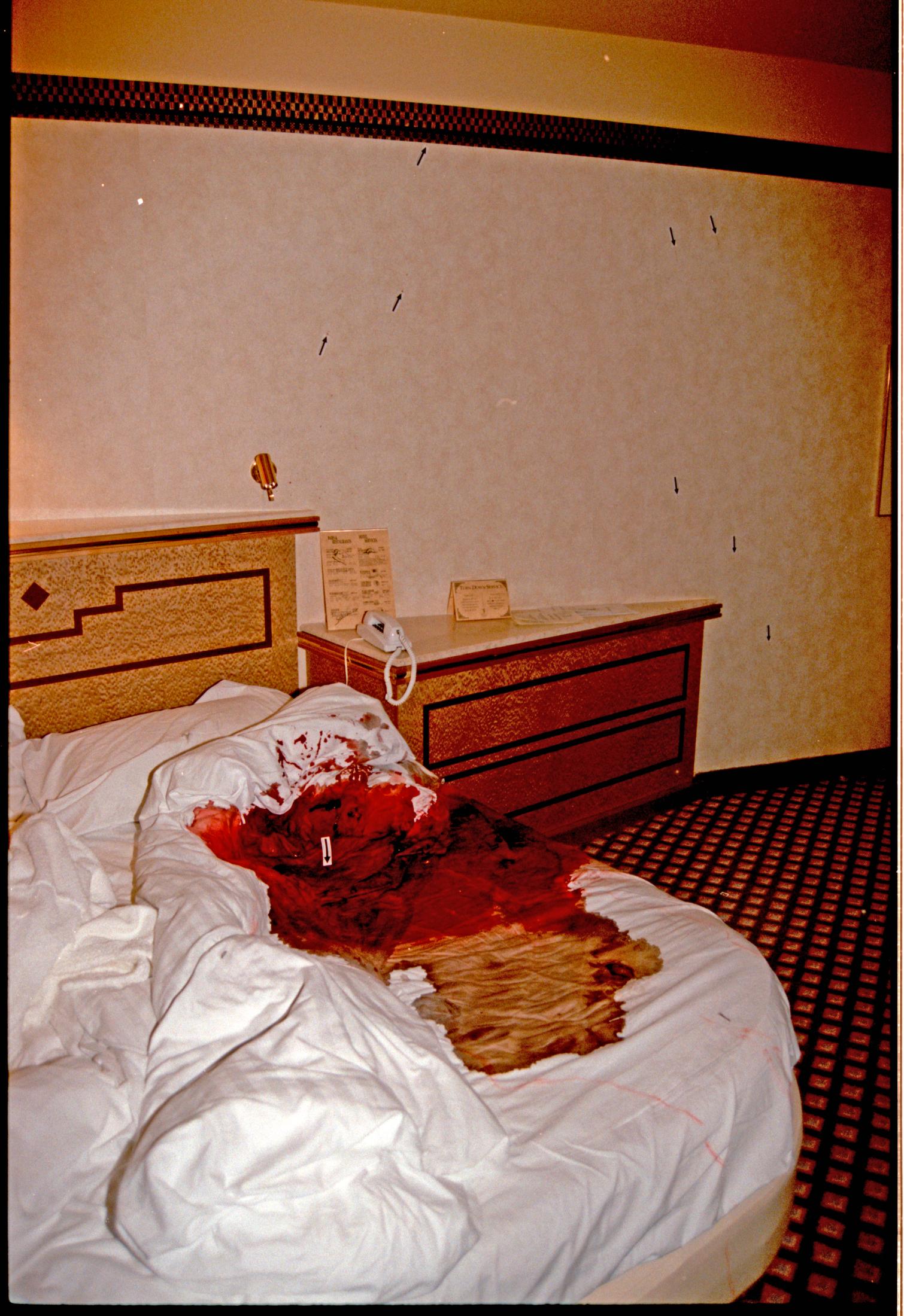 BLOOD SPATTER: There were clear blood marks on the bedside table, the phone and up the wall. Photo: POLICE.